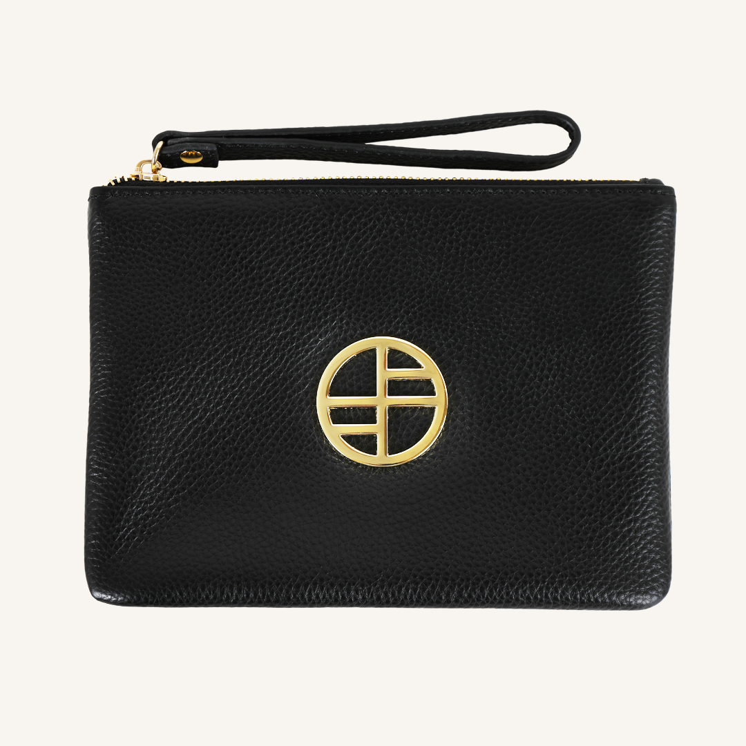 Black leather pouch bag with gold details on cream background