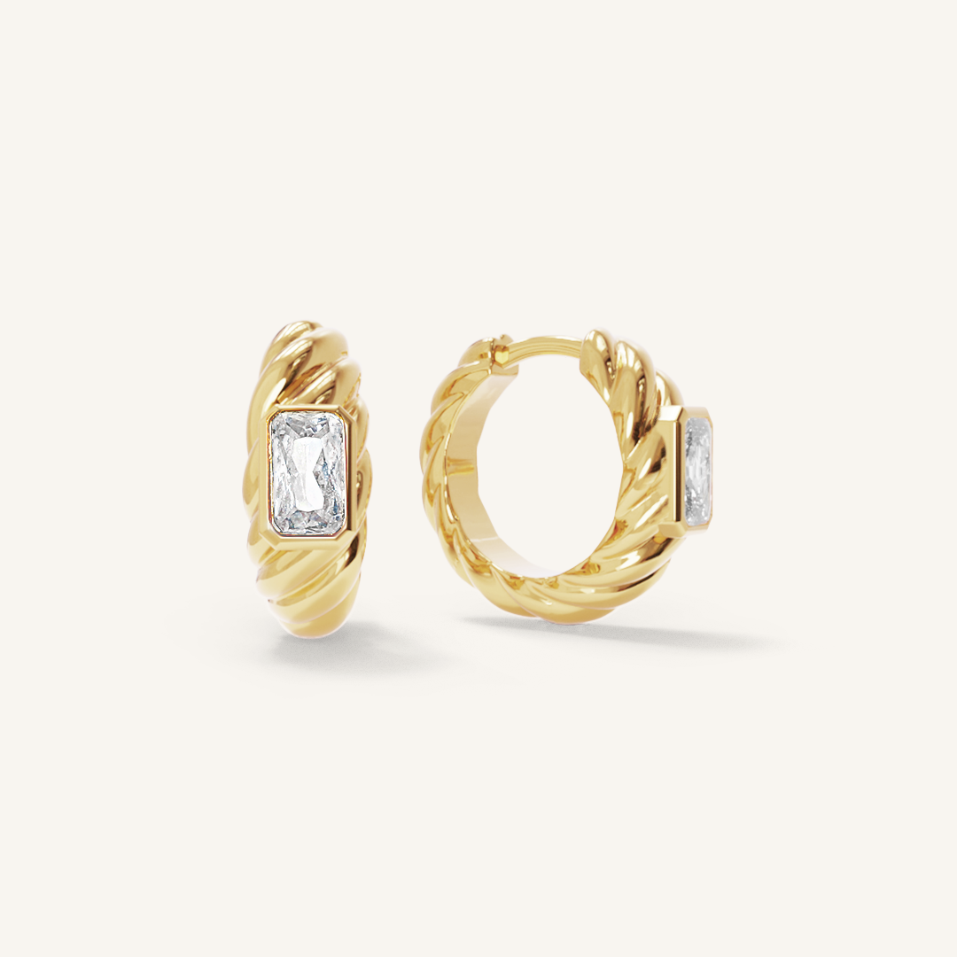 gold hoops inspired by the Louvre's architecture with Marquise cut white cubic zirconias bezel set on white background
