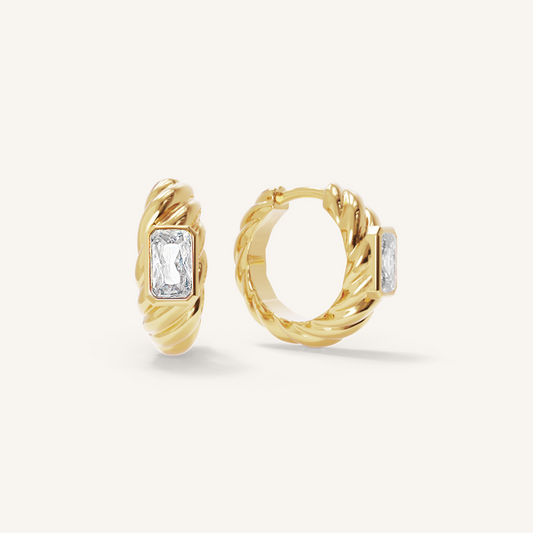 gold hoops inspired by the Louvre's architecture with Marquise cut white cubic zirconias bezel set on white background
