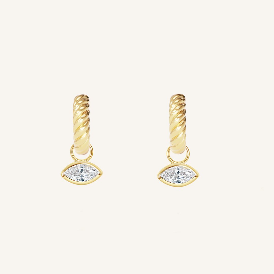 gold hoops inspired by the Louvre's architecture with Marquise cut white cubic zirconias bezel set hoop charms on white background