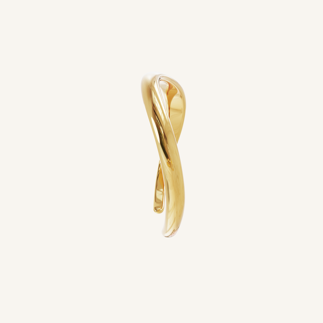 Gold cuff asymmetrical in shape with Navy, white and red cubic zirconias in a row on white background side profile