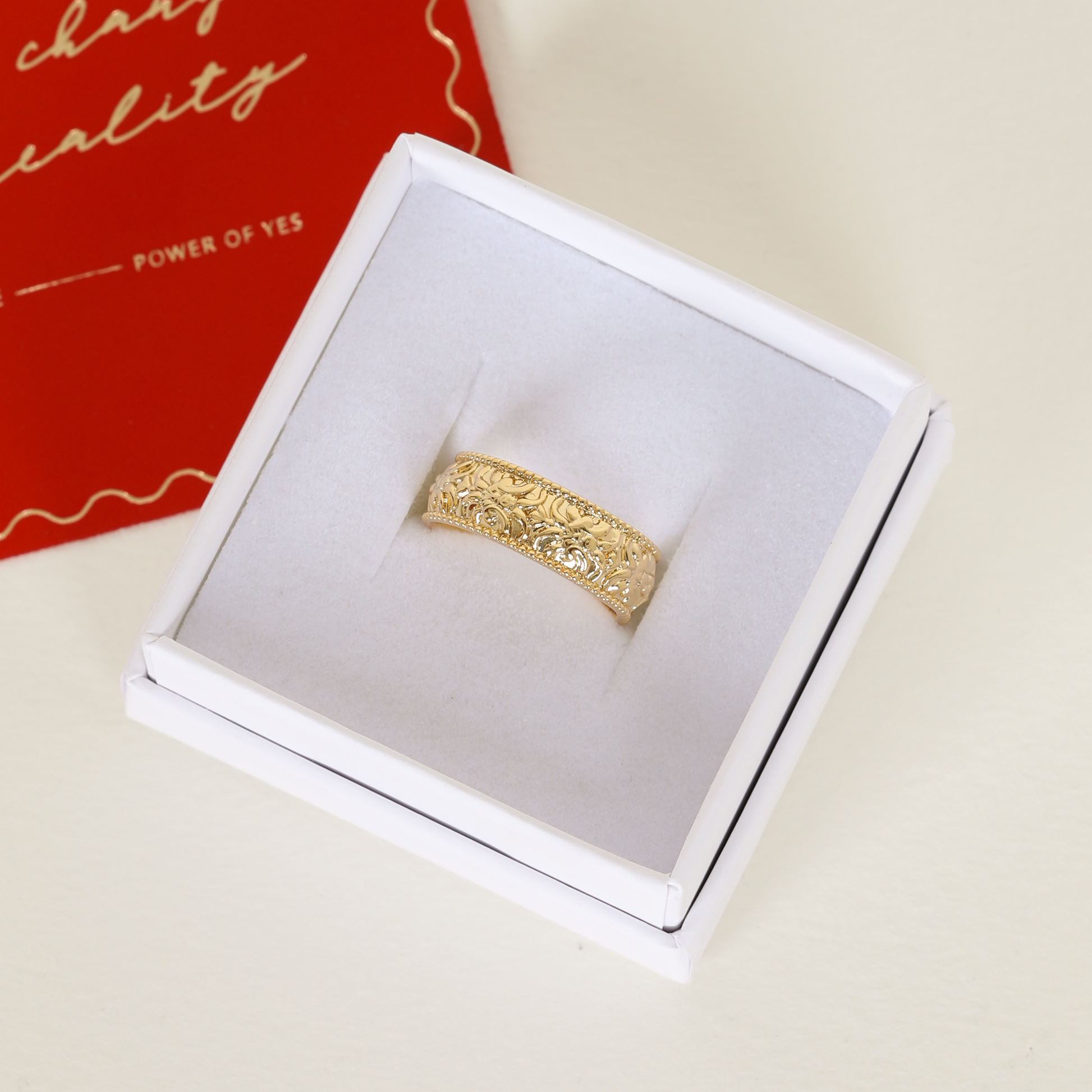 intricately designed statement gold ring inspired by Paris in white ring box