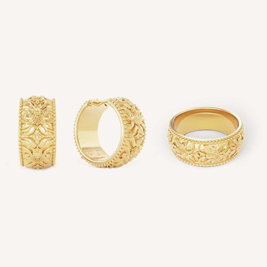 intricately designed statement gold hoops with matching ring on white background