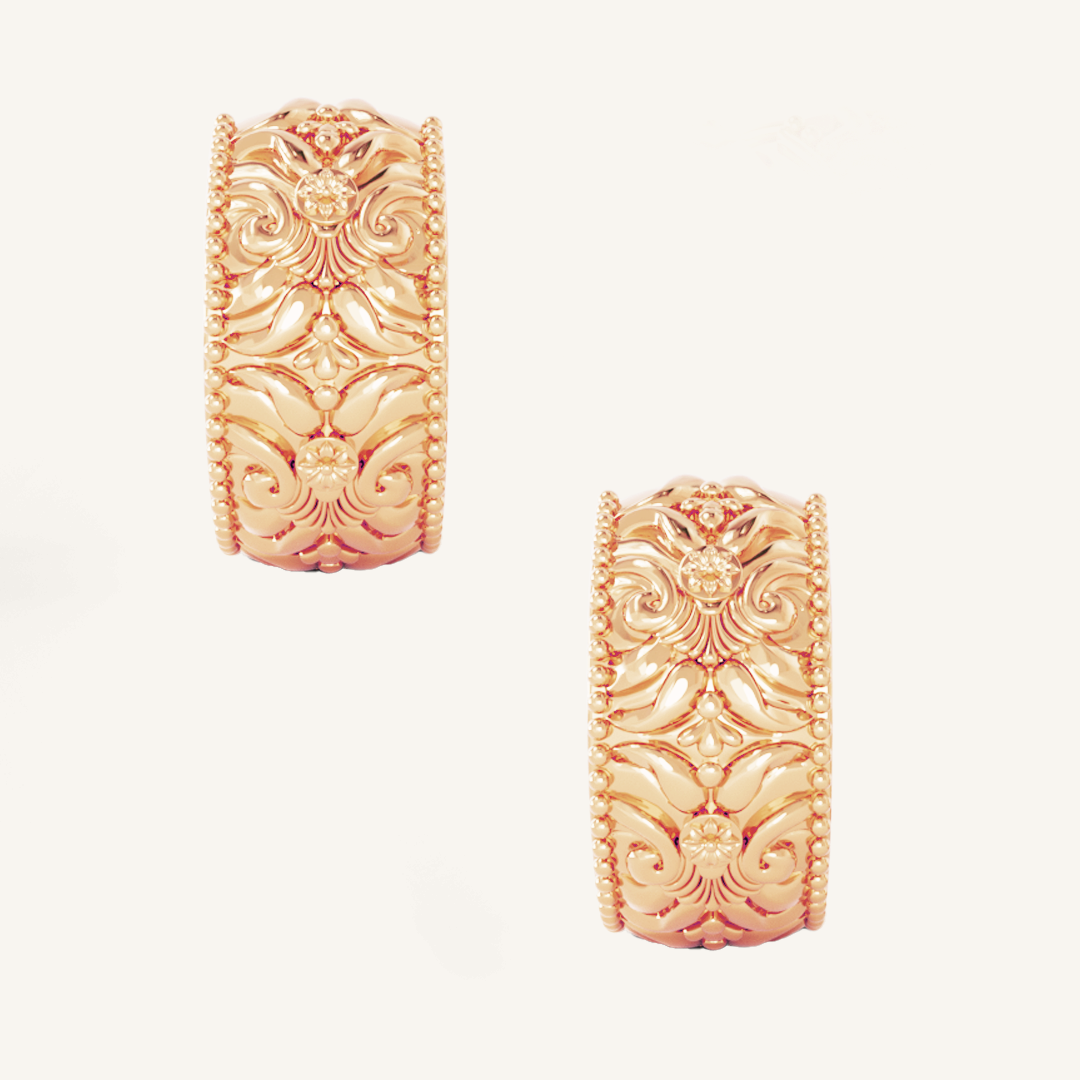 intricately designed statement rose gold hoops on white background