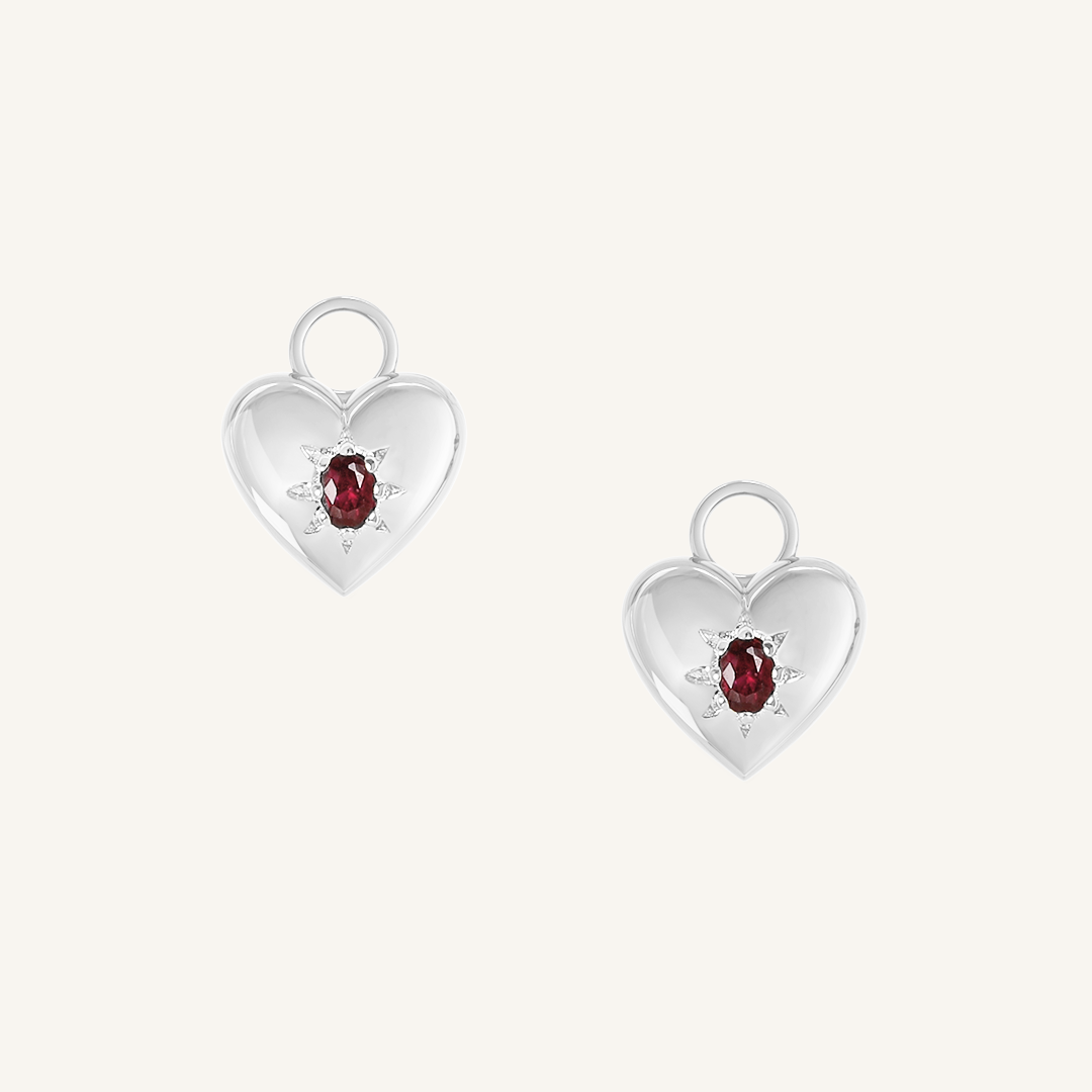 silver hoop charms with heart charms with deep red oval cubic zirconias on white background