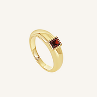 gold ring inspired by the city of love with a deep red square cubic zirconia bezel set on white background