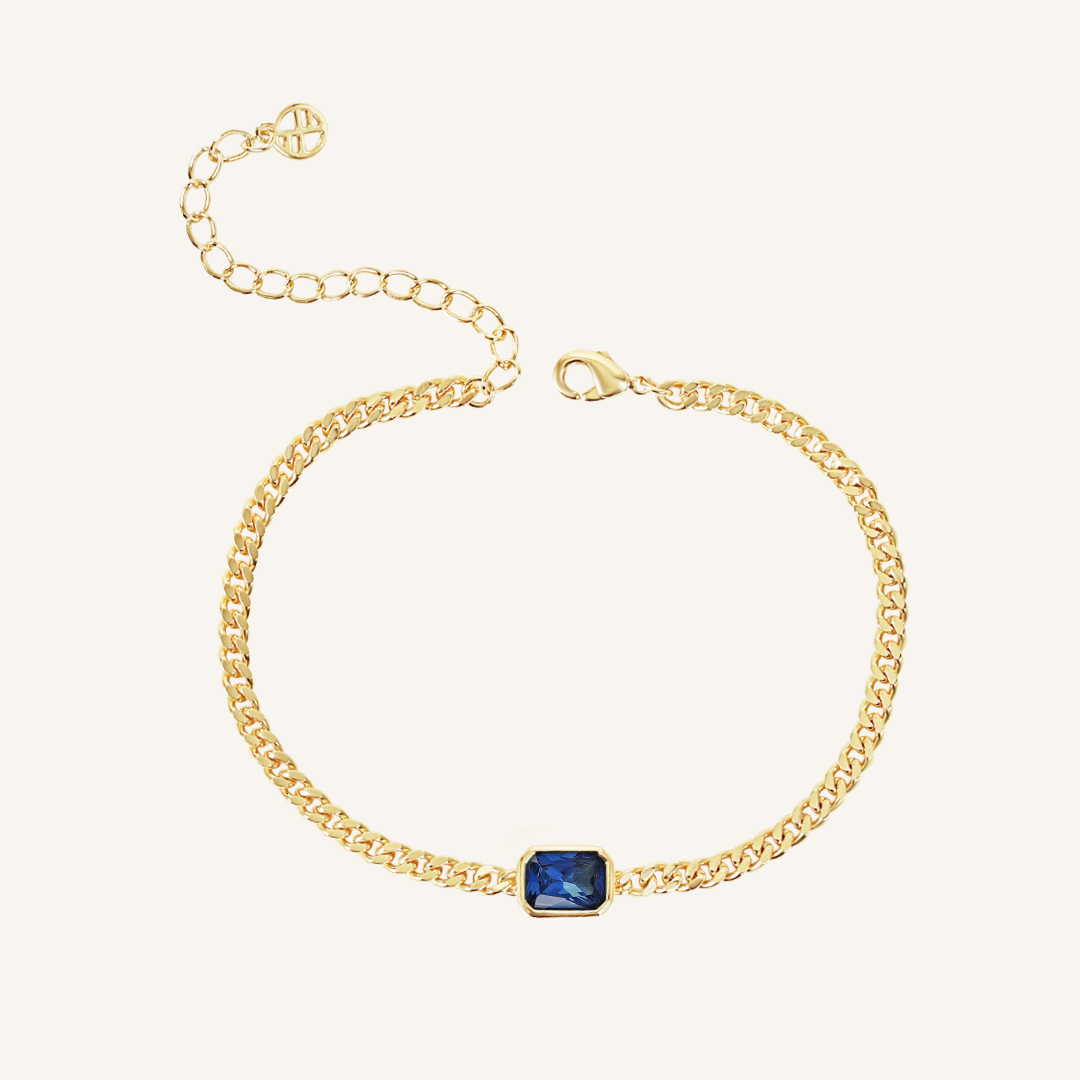 Gold chain bracelet with Navy blue cubic zirconia bezel set in centre Inspired by the halls of Versailles on white background