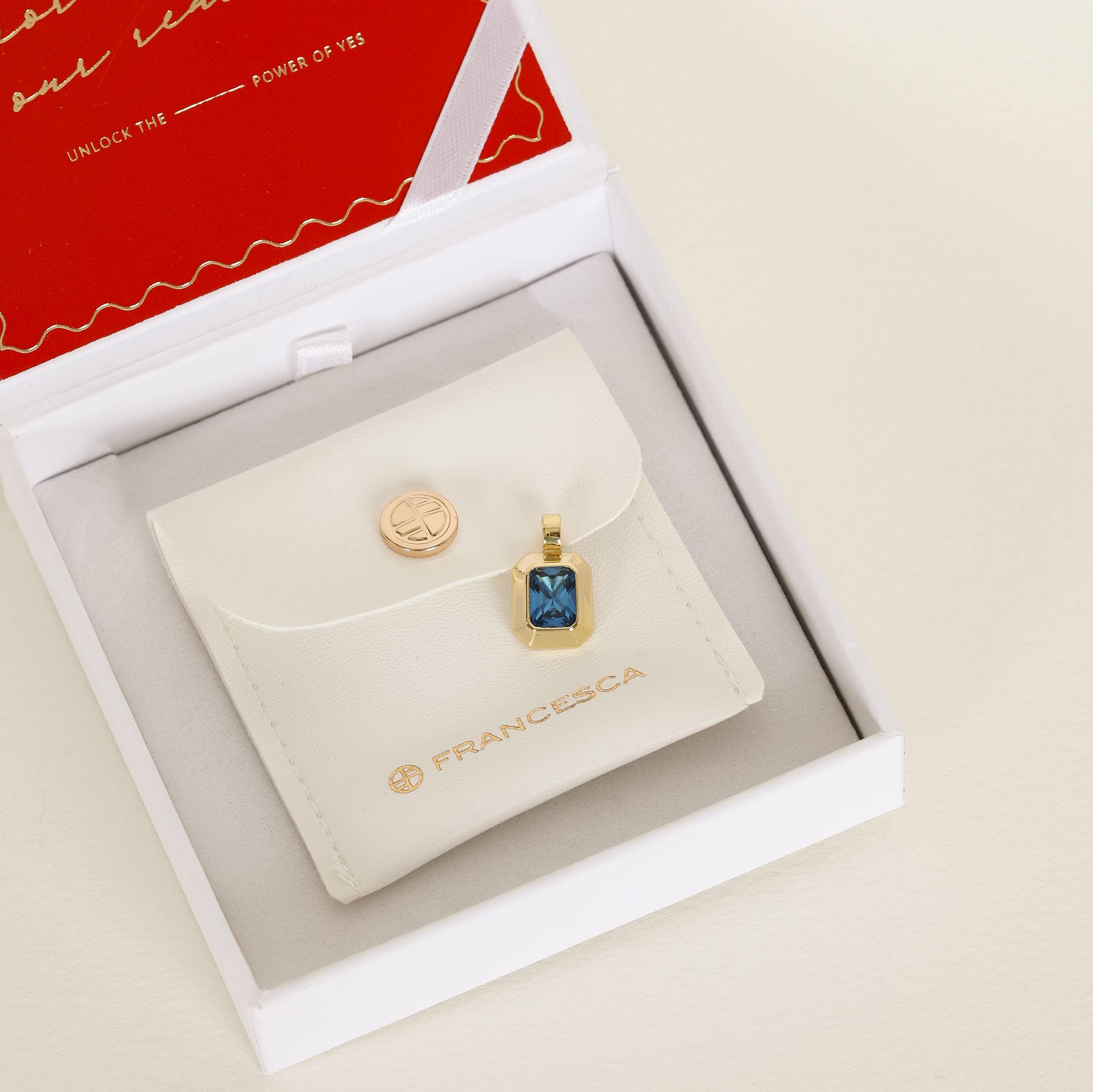 Gold charm with Blue emerald cut cubic zirconia bezel set Inspired by the halls of Versailles in white jewellery box