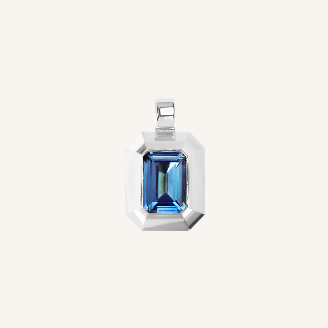 silver charm with Blue emerald cut cubic zirconia bezel set Inspired by the halls of Versailles on white background 