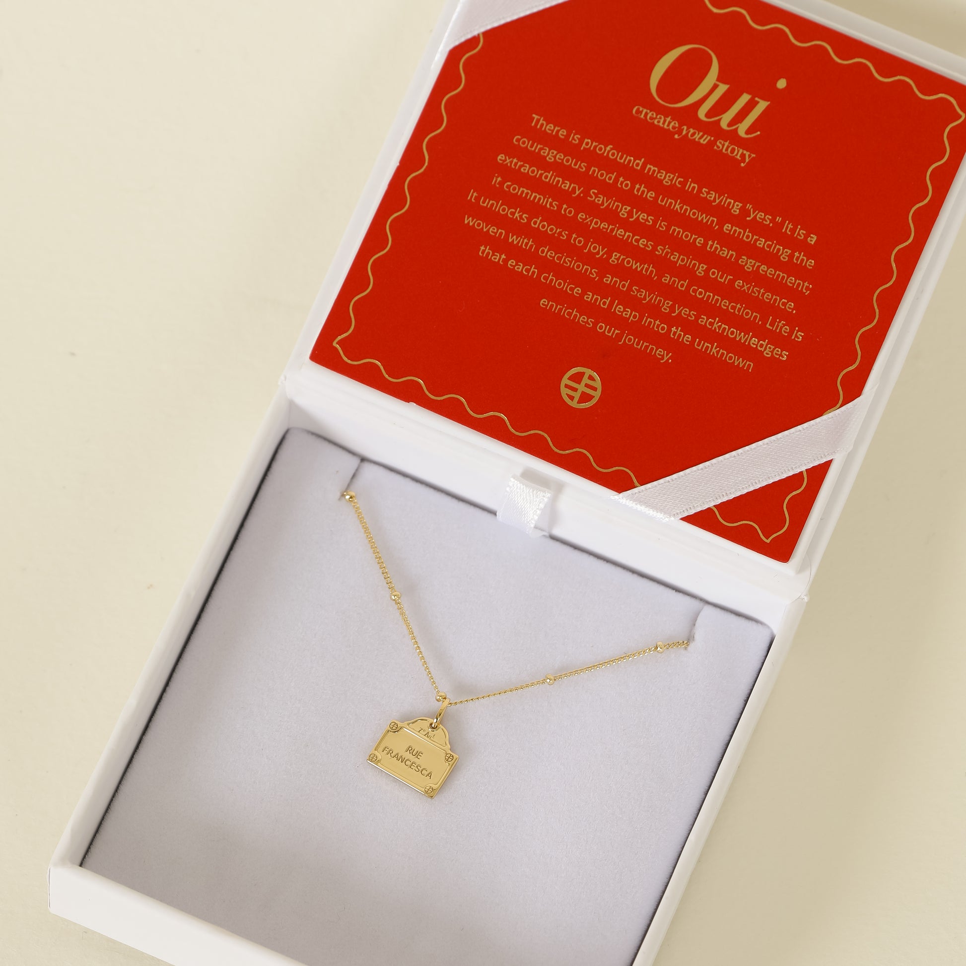 gold charm Inspired by the street signs in Paris on bobble chain on white jewellery box