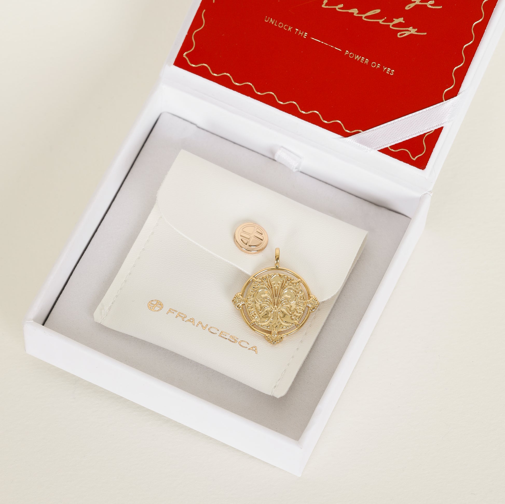 gold pendant featuring intricate patterns inspired by Palace of Versailles in gift box 