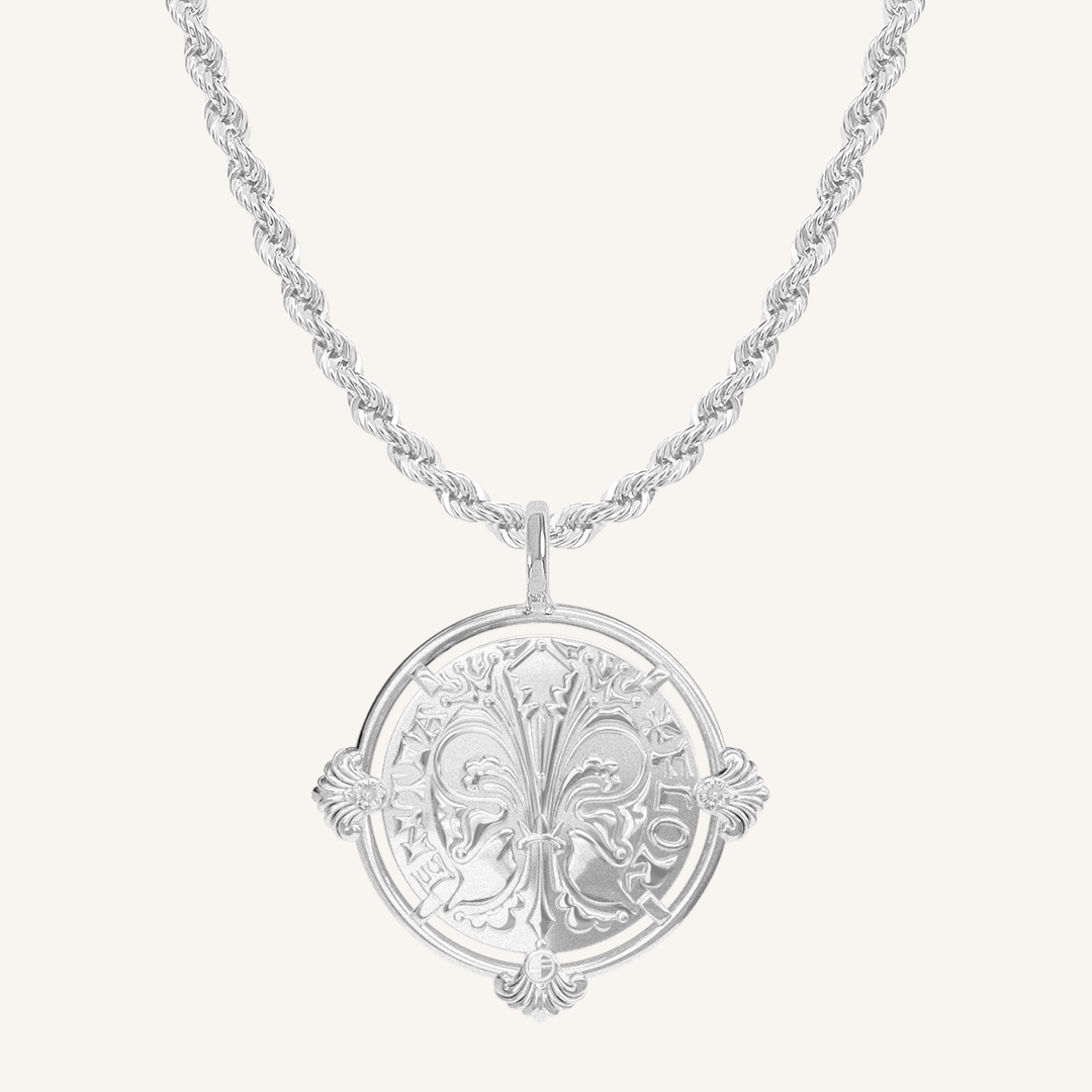 silver pendant featuring intricate patterns inspired by Palace of Versailles on silver rope chain a plain background